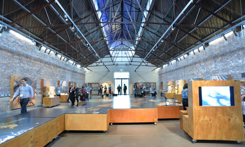 Photograph of the interior of a modern building with exhibitions set up