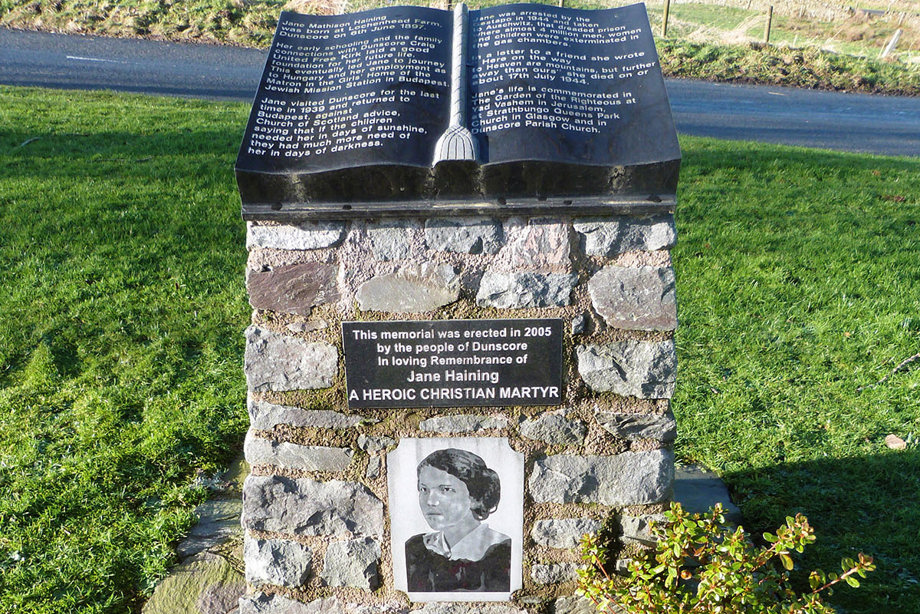 A memorial featuring a large open book and a picture of Jane Haining.